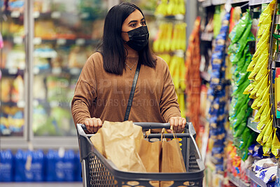 Buy stock photo Grocery shopping, woman and sale at a retail shop, market and store for groceries with mask. Health, virus safety and young female person with cart and food purchase in a supermarket at shelf