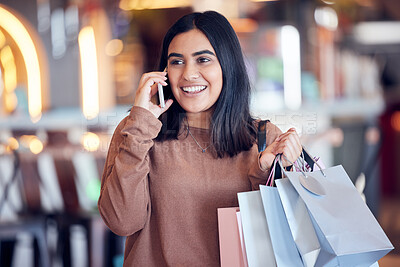 Buy stock photo Shopping, phone call and Indian woman in mall with smile for communication, conversation and chat. Retail, fashion and happy female person talking on smartphone for sale, bargain and discount news