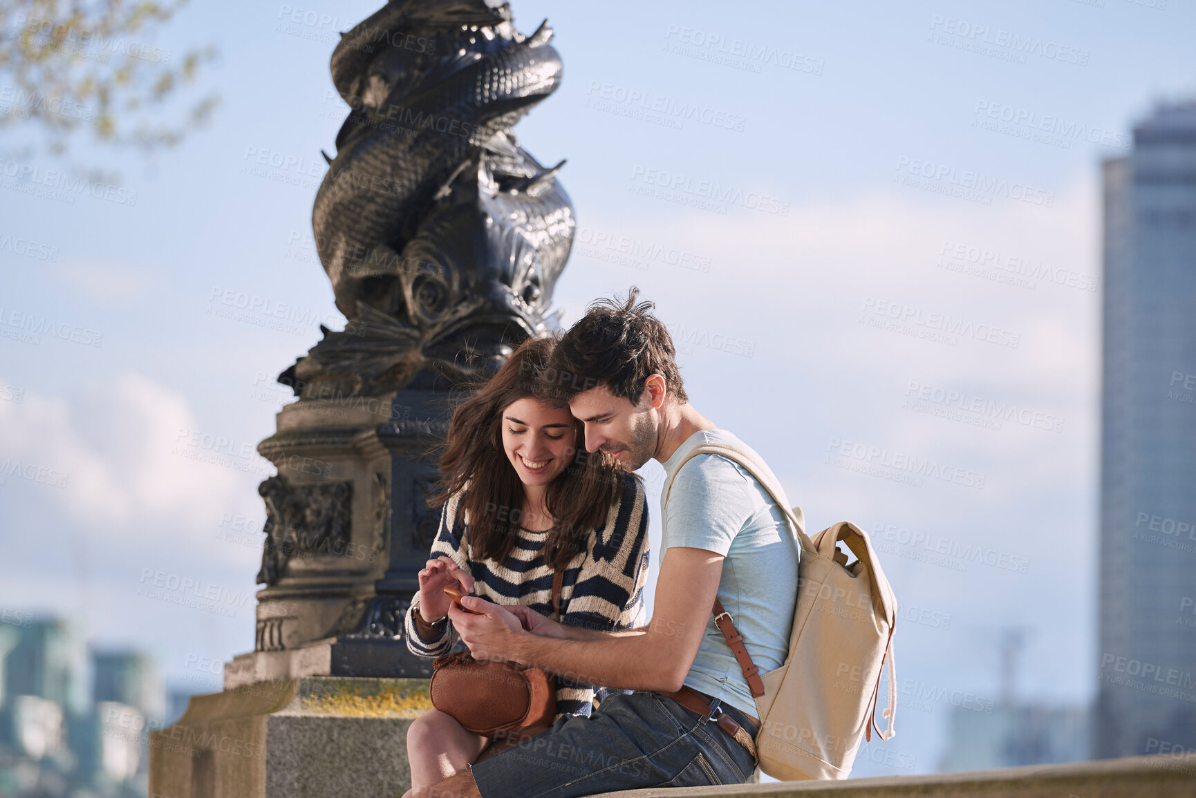 Buy stock photo Couple, phone and travel holiday while at statue doing search on internet for map information on tourist trip. Man and woman with cellphone for social media content on foreign city journey in London