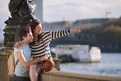 Buy stock photo Travel, love and honeymoon with a young couple pointing while sightseeing on an overseas trip abroad together. Water, city and summer with a man and woman bonding or traveling in a foreign country