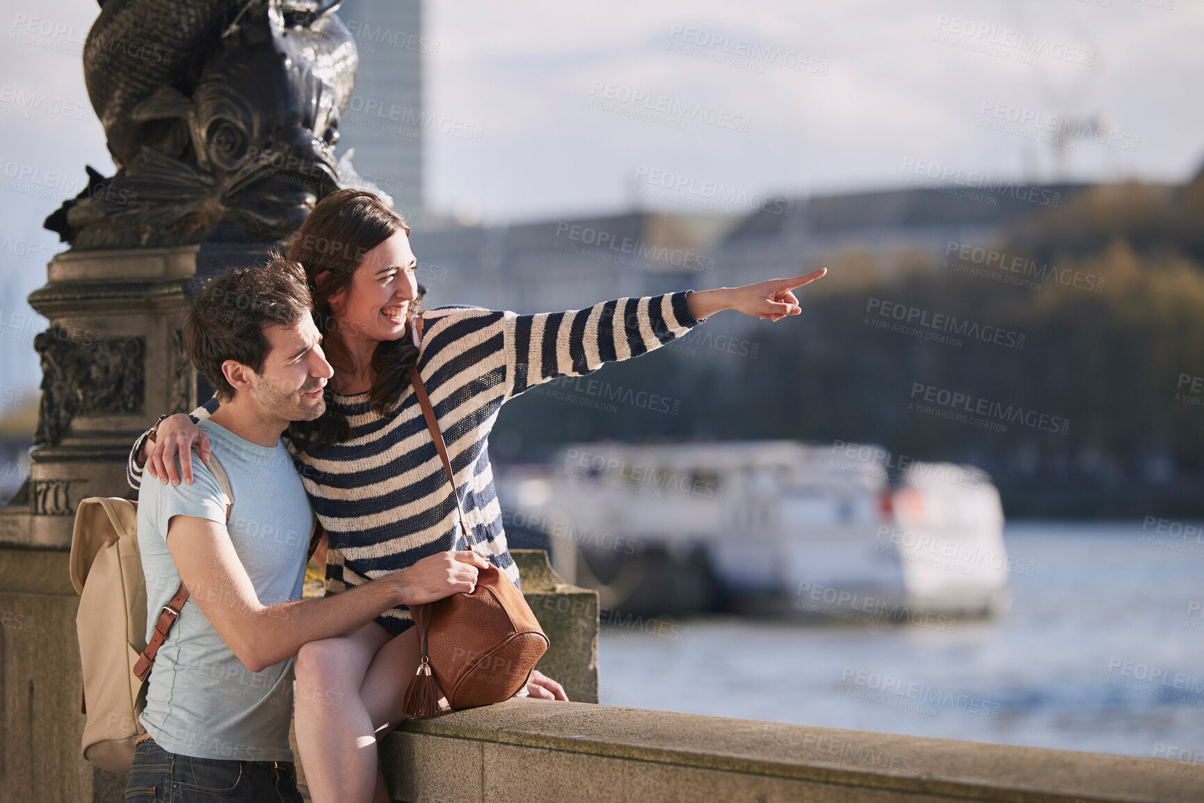 Buy stock photo Travel, love and honeymoon with a young couple pointing while sightseeing on an overseas trip abroad together. Water, city and summer with a man and woman bonding or traveling in a foreign country