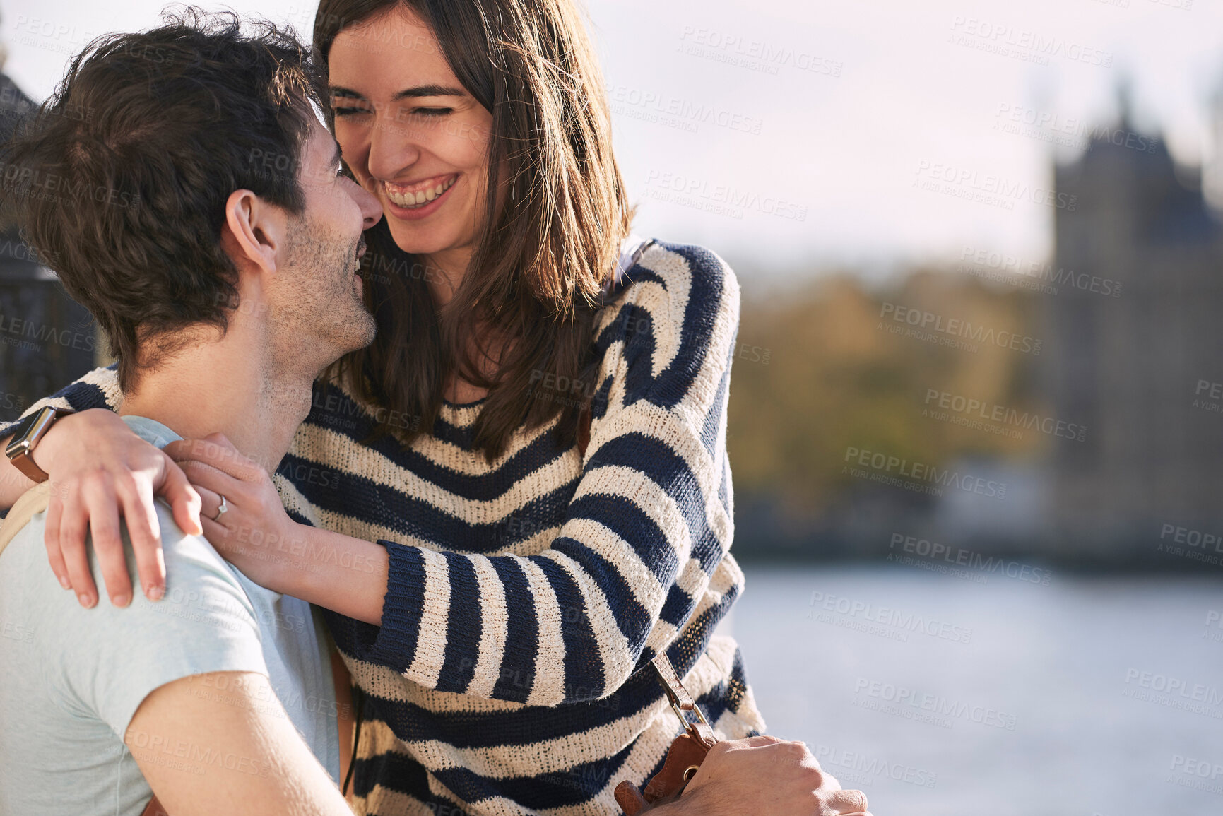 Buy stock photo Love, travel and happy with couple in London for adventure, vacation and destination. Affectionate, hug and smile with man and woman in city at river thames for holiday, embrace and abroad trip