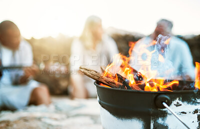 Buy stock photo Closeup hot, warm and burning fire outside during a camp, trek or hike in nature. Group of friends taking a break from an adventure, journey or hiking outside near a flame in the rural wilderness
