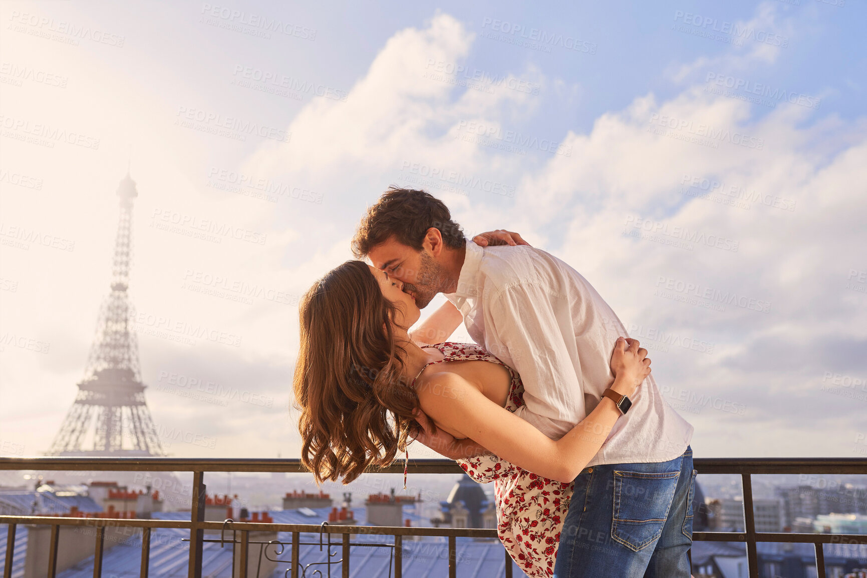 Buy stock photo Paris, love and couple together for a kiss, romantic time or balcony of apartment, hotel with Eiffel Tower in background. Partner, woman and man in France for vacation, travel or honeymoon holiday