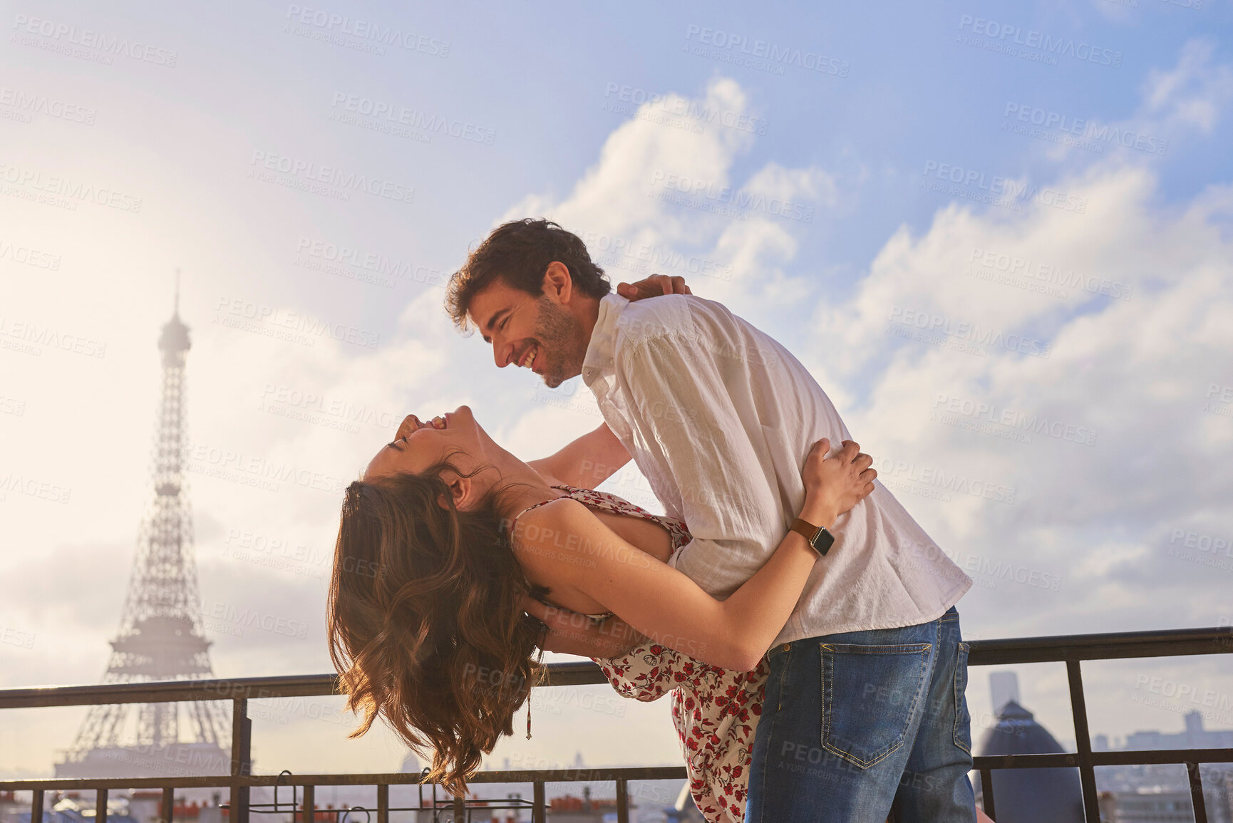 Buy stock photo Love, Paris and couple together for a kiss, romantic time or balcony of apartment, hotel with Eiffel Tower in background. Partner, woman and man in France for vacation, travel or honeymoon holiday