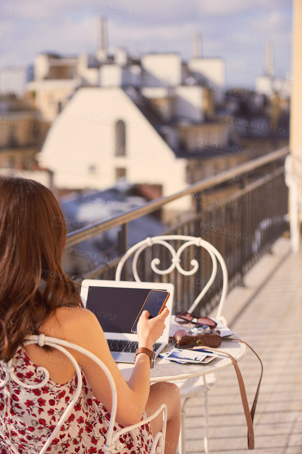 Buy stock photo Phone, laptop and woman on balcony in France for social media, internet and online post. Happy, morning and person relax on smartphone or tech for tourism website on holiday, vacation and travel