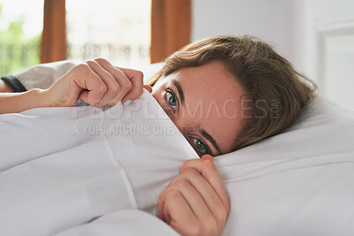 Buy stock photo Portrait, woman and peeking in bed cover to wake up, relax and peace in home bedroom. Hiding face, morning and person in duvet for comfort, healthy rest and eyes of shy girl on pillow in Switzerland