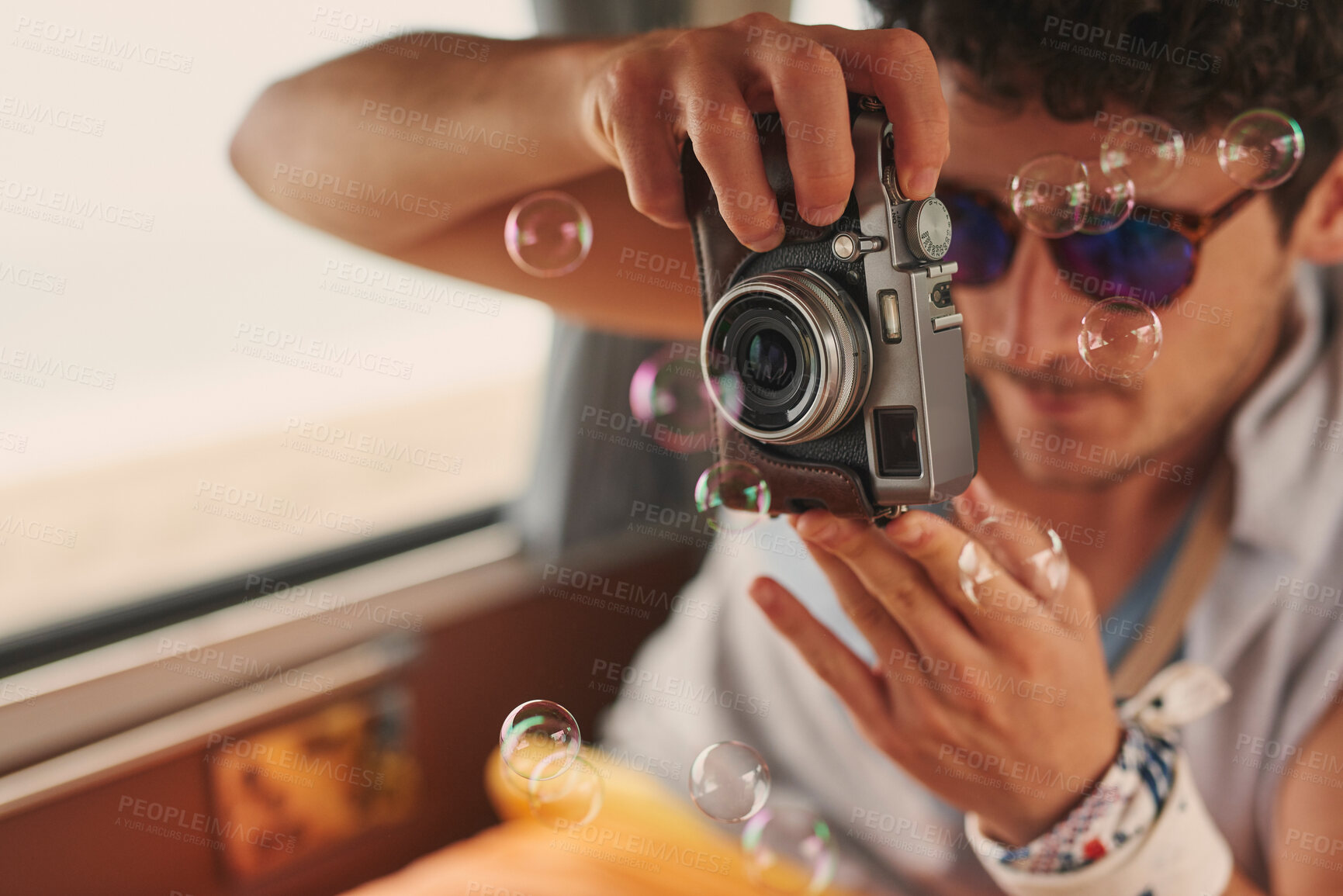 Buy stock photo Man, photography and digital camera in car on road trip for memories, travel and journey. Male person, bubbles and tourist in minivan or vehicle as transport for summer holiday, photo album and break