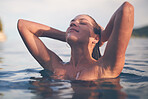 Sexy young woman swimming in the sea. Enjoying a summer vacation and relaxing weekend