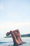 Sexy young woman swimming in the sea. Enjoying a summer vacation and relaxing weekend