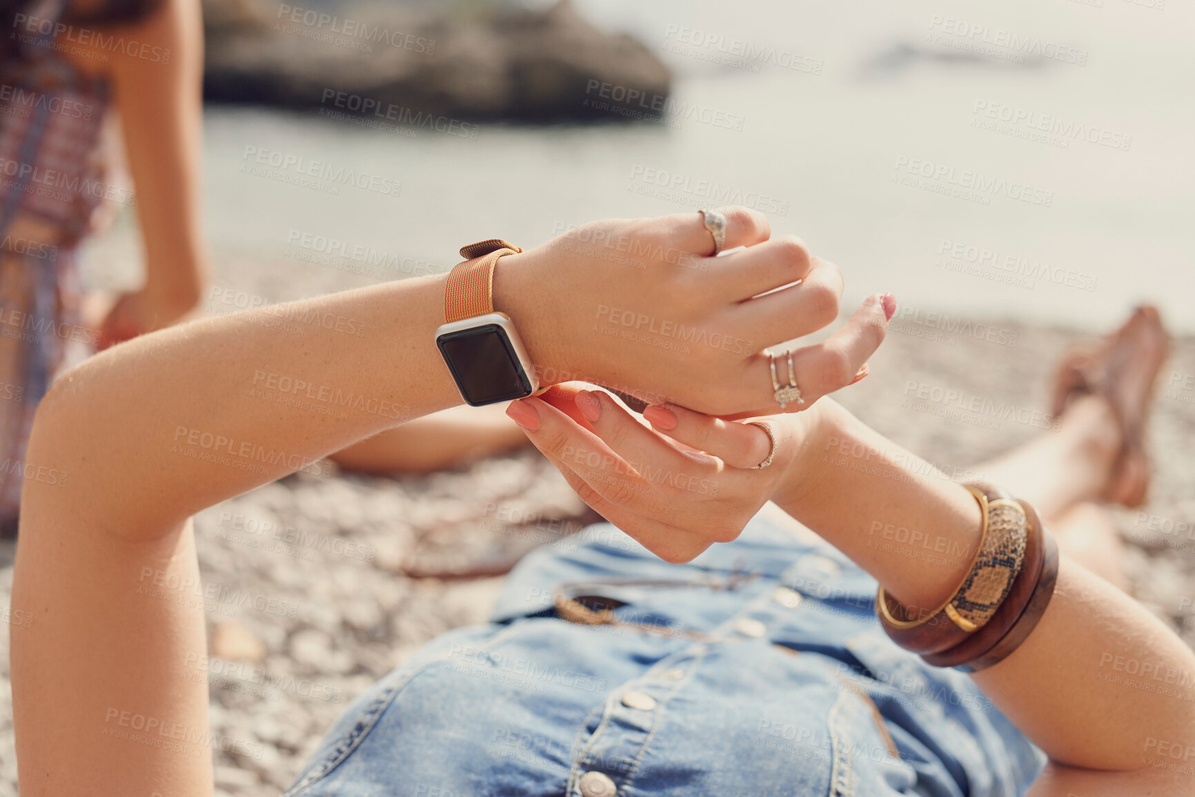 Buy stock photo Beach, smart watch and hands of girl with technology for wellness check, reminder or notification. Holiday, relax and woman at sea with gadget device for reading message, application or adventure