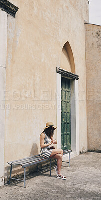 Woman using smartwatch on summer vacation in Italy. Beautiful girl checking time on wristwatch