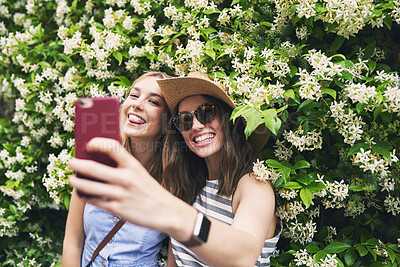 Buy stock photo Two friends taking selfies on summer vacation. Girl friends on travel adventure taking photos for social media with smartphone