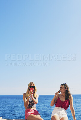 Buy stock photo Two friends taking photos of ice cream eating on beach using smart phone technology on adventure travel