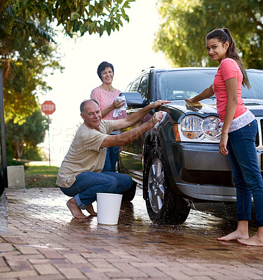 Buy stock photo Portrait of a family washing a car together outside