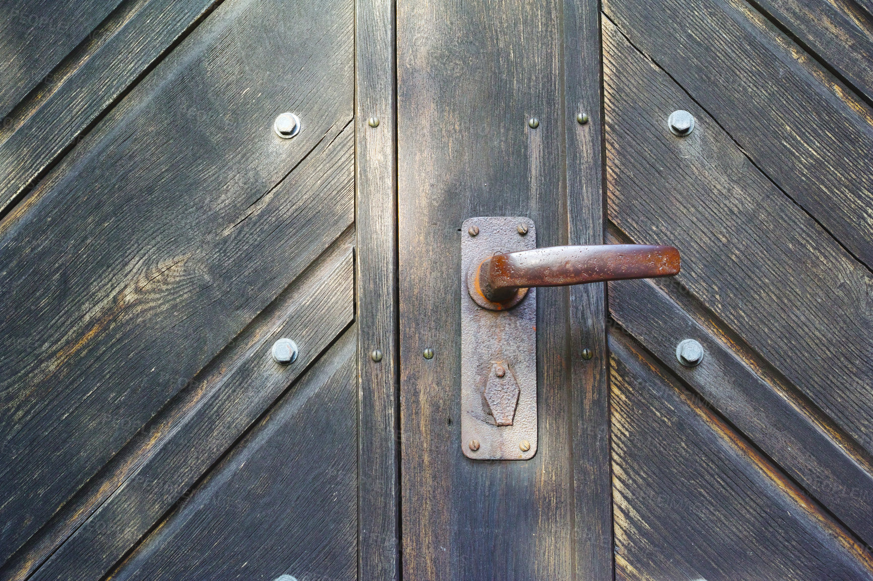 Buy stock photo Closeup, door and handle with rusty metal for old exterior, damage or vintage doorframe of abandoned home. Empty, entrance or weathered wood with poor lock for bad maintenance, safety or security