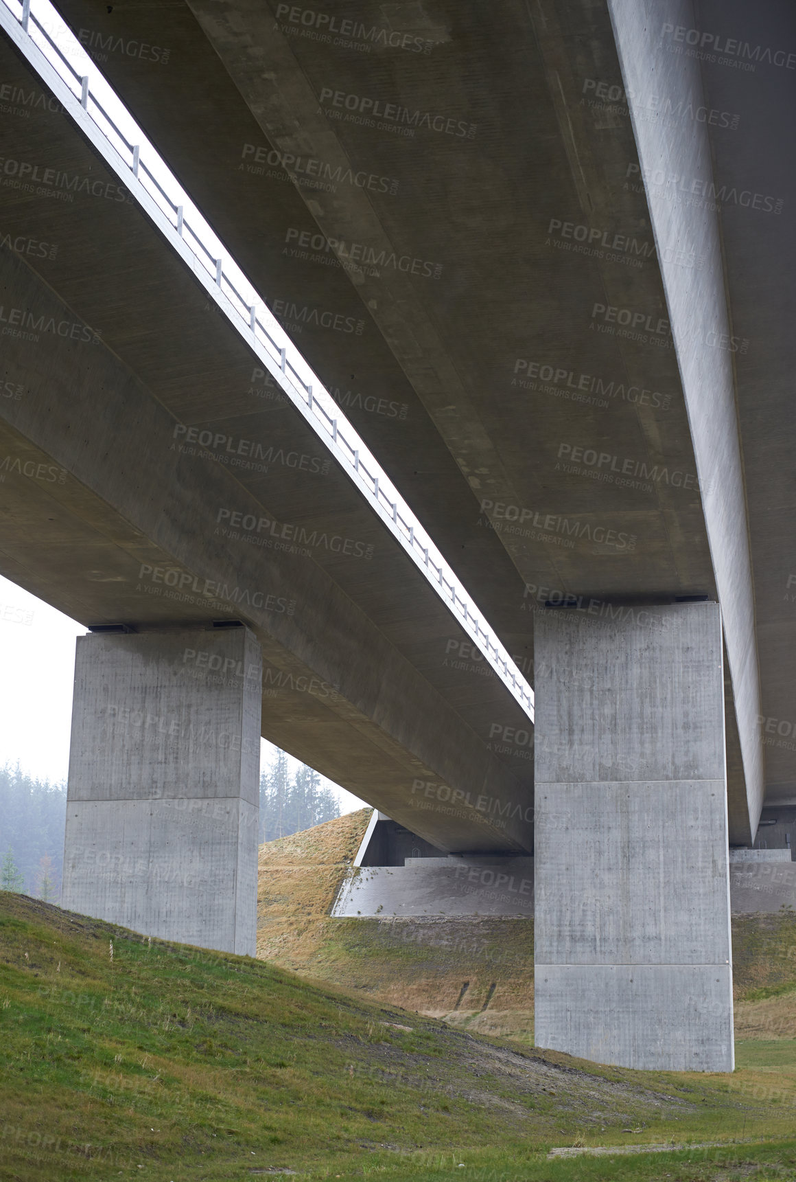 Buy stock photo Bridge, architecture and grass field with concrete pillars for urban structure, cement or crossing in countryside. Empty, architectural building or land construction with nature for path or route