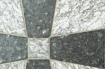 Buy stock photo Closeup of black and grey granite tiles on a floor. Creative architecture design of granite tiles cemented together to form a cross pattern. Texture background of natural stone for interior design