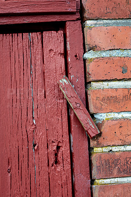 Buy stock photo Closeup of an old red wooden door in a face brick building,most likely a house in a residential district. A latch lock on an entrance way