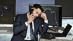 Stressed businessman on the phone, trading on the stock market during a financial crisis. Trader in a bear market with stocks crashing. Market crash and economy depression or failure