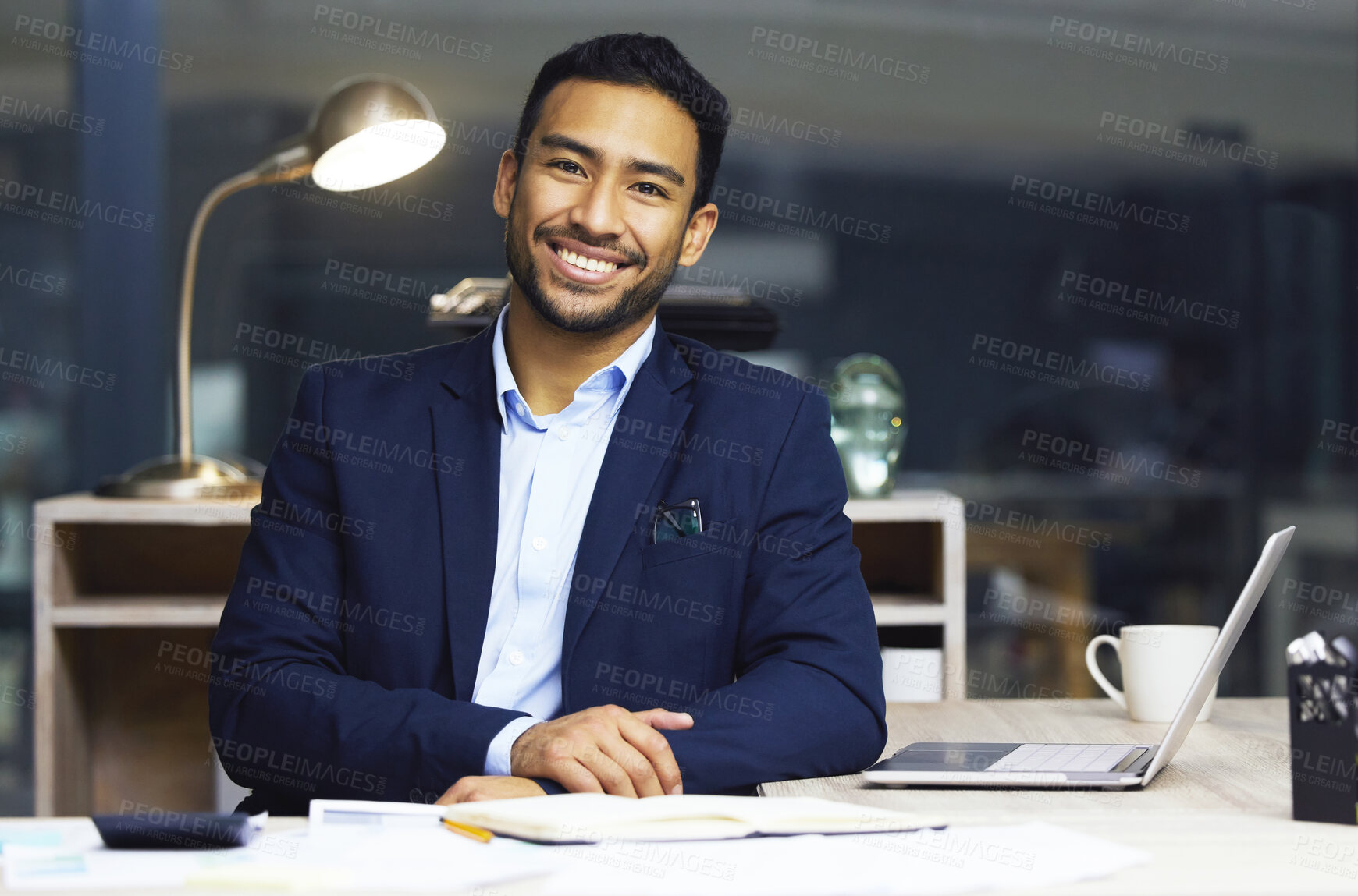 Buy stock photo Happy young businessman trading on the stock market. Portrait of a smiling trader working online  and going through paperwork. Stock market and economy financial status