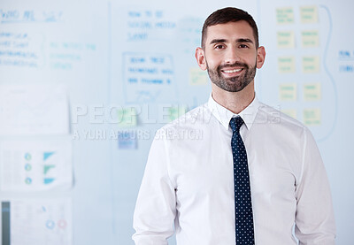 Buy stock photo Portrait of smiling caucasian businessman standing alone in an office. Young happy professional feeling confident after using a whiteboard to brainstorm a strategy. Leading in business by planning