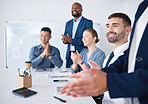 Diverse group of smiling business people clapping during boardroom meeting in office. Happy team of male and female professionals celebrating success. Confident colleagues cheering after brainstorming