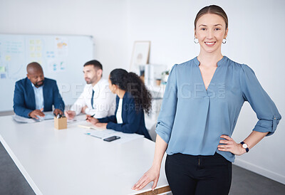 Buy stock photo .Portrait of confident smiling caucasian businesswoman leaning on a desk in aa boardroom. Diverse group of businesspeople in a meeting and working behind a happy young business manager in an office