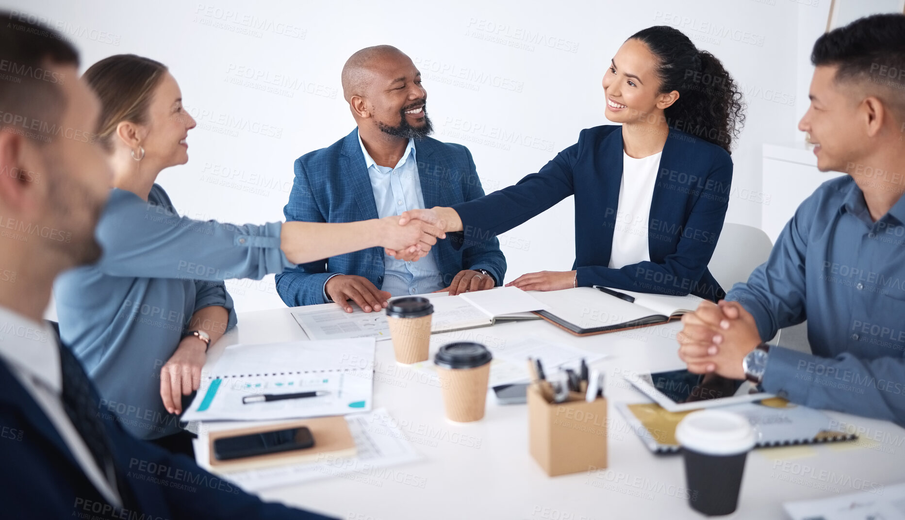 Buy stock photo Team of smiling diverse business people shaking hands in office after meeting in boardroom. Group of happy professionals and colleagues using handshake and gesture to congratulate success and welcome