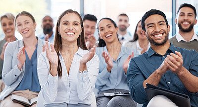 Diverse group of smiling businesspeople clapping in office training. Team of professional colleagues cheering and celebrating together while learning in workshop. Attending a seminar for marketing