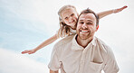 Smiling father piggybacking daughter with arms outstretched