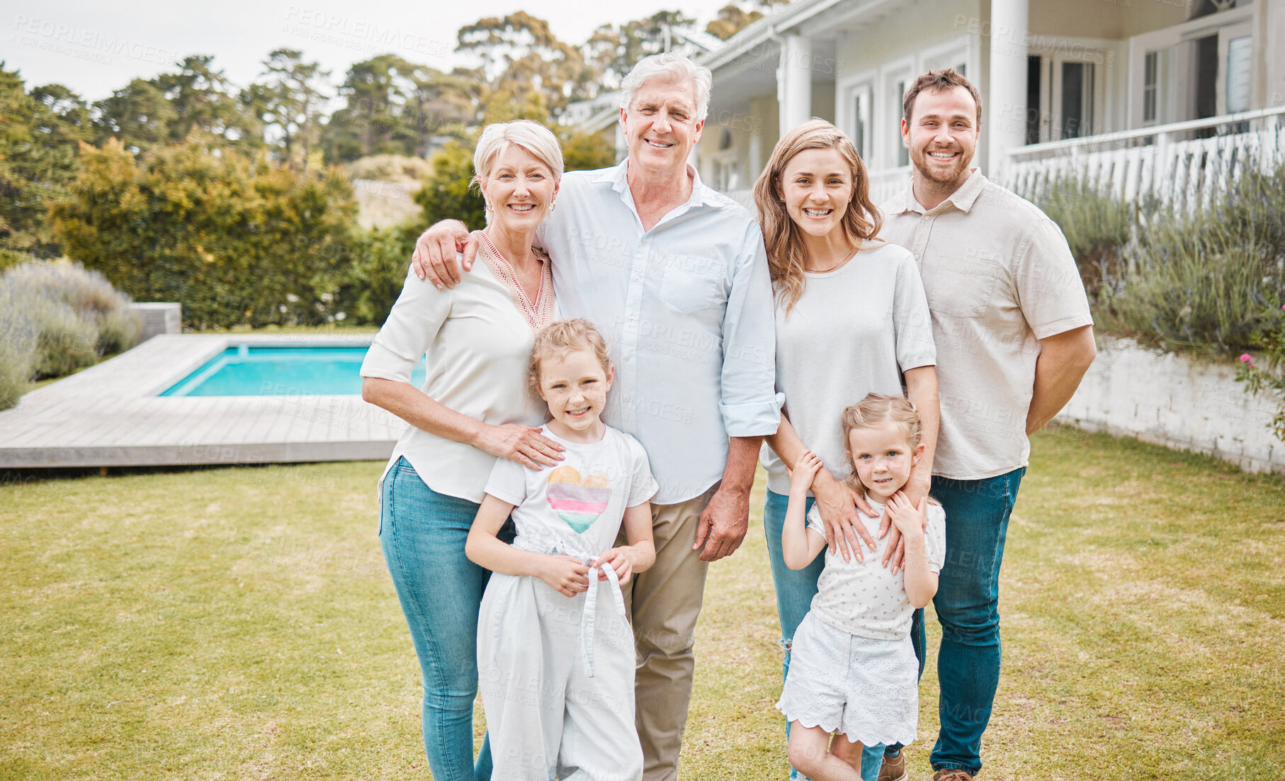 Buy stock photo Portrait, property and a family in the garden of their new home together for a visit during summer. Children, parents and grandparents in the backyard of an apartment for real estate investment