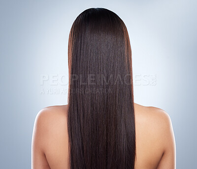Rear view of a young woman with beautiful long smooth hair. Close up of a woman with luxurious straight and shiny brown hair. Healthy hair against studio background
