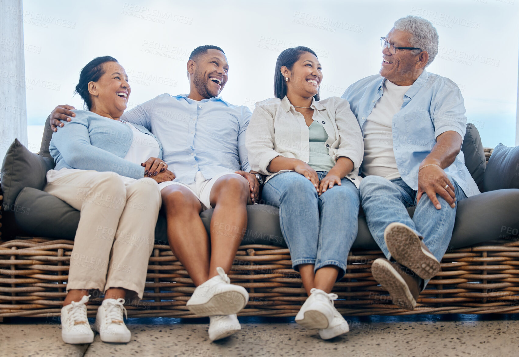 Buy stock photo Happy family, together and laugh on couch at home, outdoors or backyard for funny joke, story or memory. Mature parents, young couple and smile on face for bonding, relationship and care with embrace