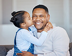 Adorable little girl kissing her dad on the cheek. African american man laughing and looking joyful while receiving love and affection from his daughter. Man being spoiled on father's day