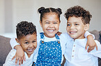 Three happy and adorable mixed race kids having fun and laughing together at home. Group of boys and girl siblings or cousins playing and bonding while growing up together. The innocence of childhood