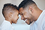 Cute little boy and dad touching foreheads. Closeup of happy dad and son looking into each other's eyes. African american family expressing love and support, enjoying tender moment together at home
