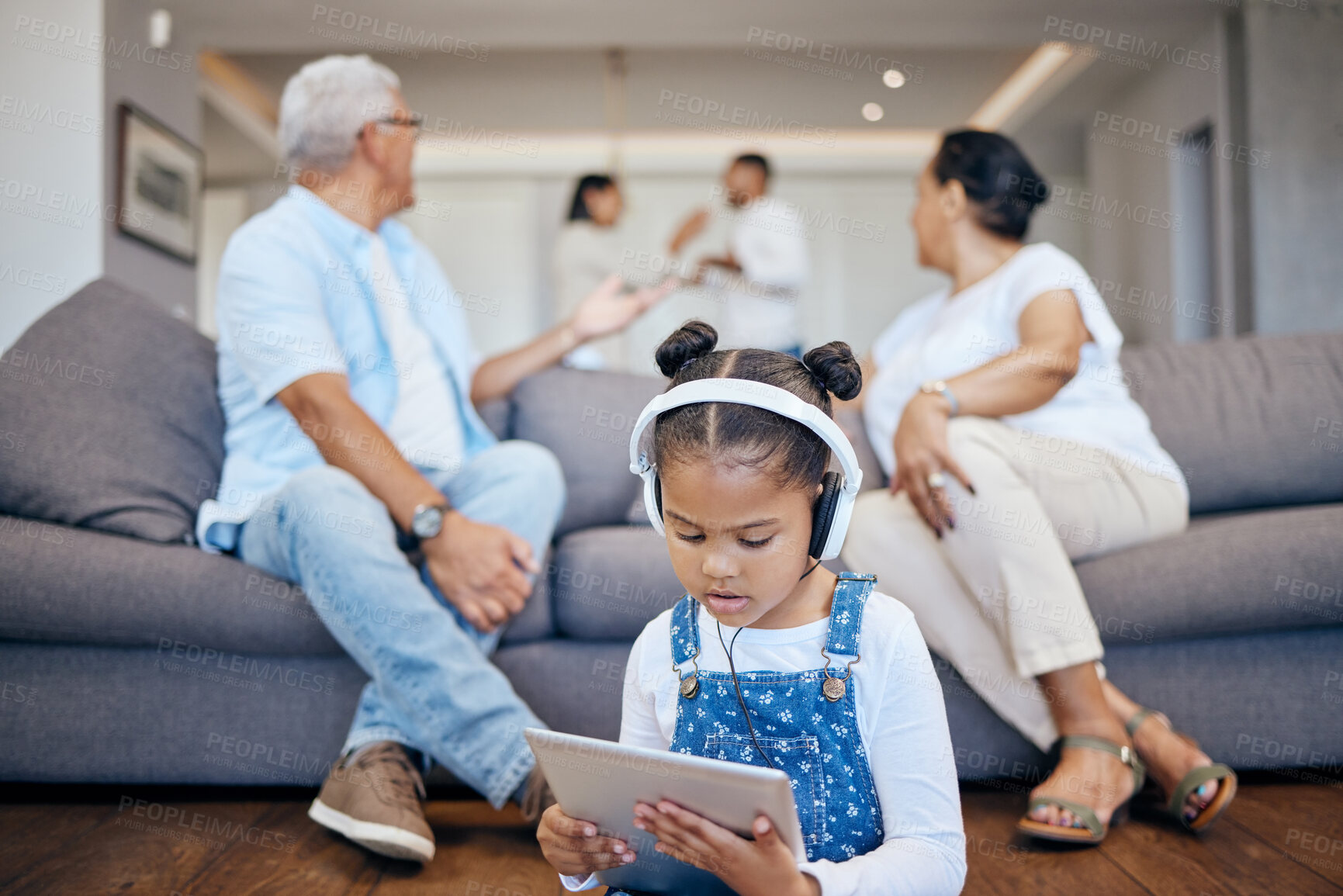 Buy stock photo Child, listening to headphones and tablet with parents fighting in lounge, argue and shout for problems. Broken home, trauma and mental health issue for kid, hear or streaming and grandparents
