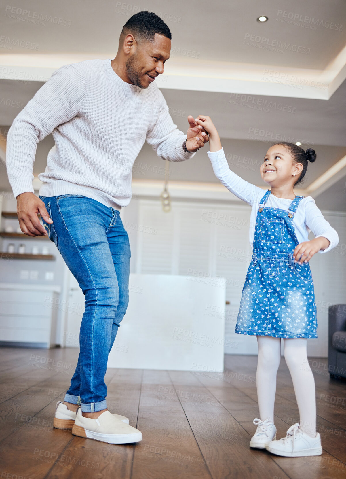 Buy stock photo Dance, love or energy with a father and daughter having fun in the living room of a home together. Family, smile or happy with a man and an excited girl child moving in their apartment for freedom