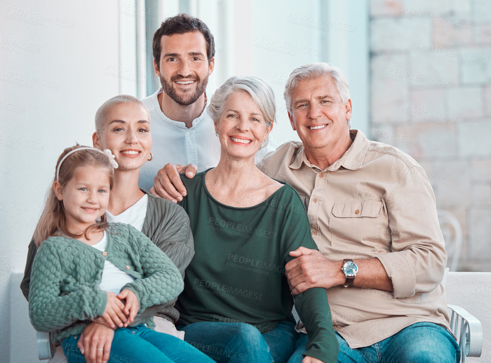 Buy stock photo Grandparents, parents and girl on sofa, portrait and hug with care, bonding and love in family home lounge. Mom, dad and child with embrace for smile, relax and together on living room couch in house