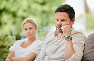 Sad man looking disappointed and ignoring wife after argument. Middle aged man thinking about divorce after fight and having relationship troubles