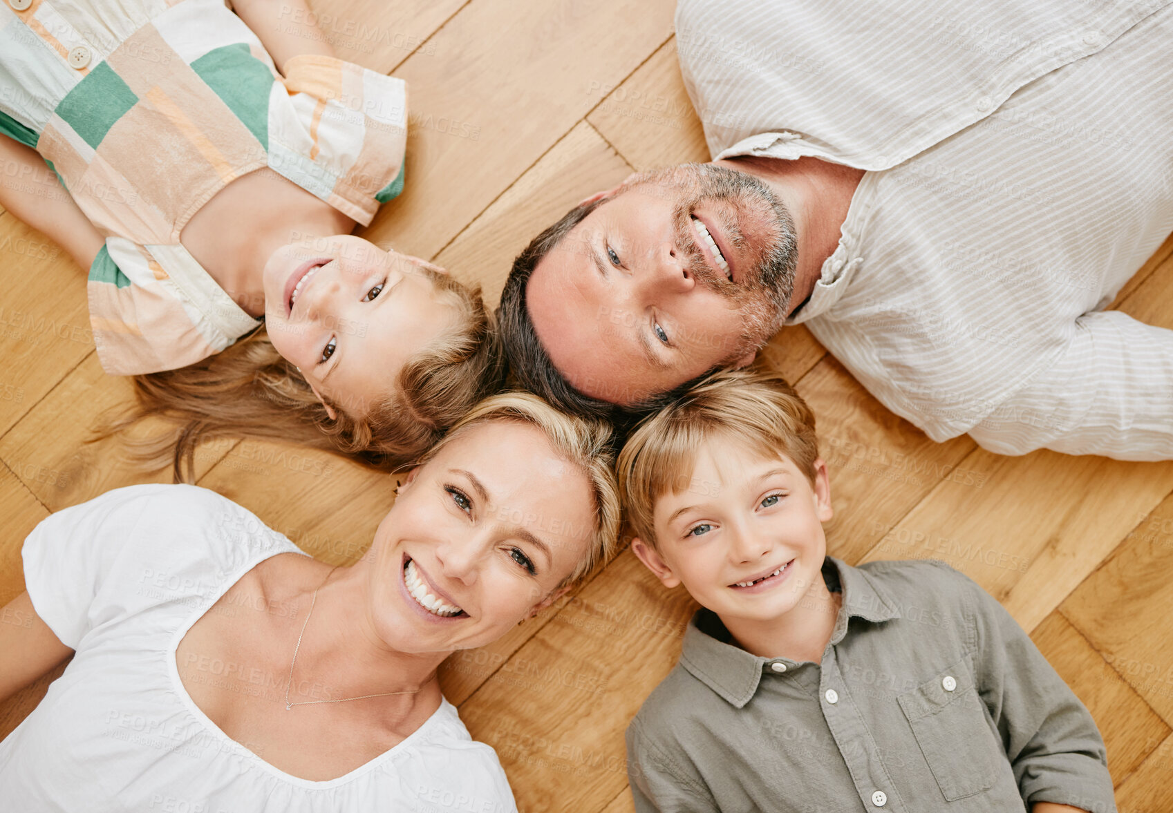 Buy stock photo Family, portrait and above of parents and kids with smile for bonding, relationship and relax at home. Happy, face and top view of mother, dad and children in living room for love, care or childhood