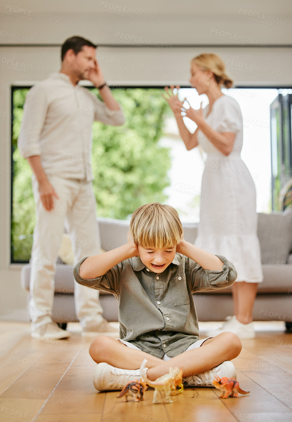 Buy stock photo Divorce, fear and a boy with parents fighting in the living room of a home with stress or anxiety. Family, trauma or conflict and a child covering his ears while mom and dad argue about breakup