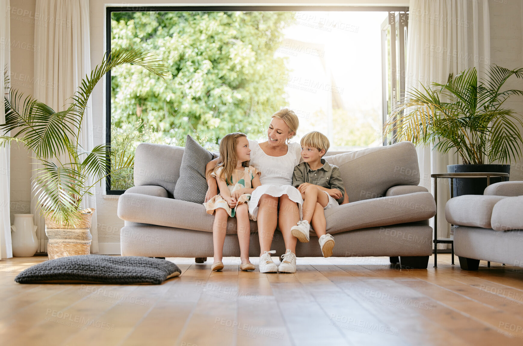 Buy stock photo Family, smile and relaxing on couch, conversation and bonding at home, fun and communication. Mother and children, connection and security in relationship, happy and care in speaking, chat and sofa