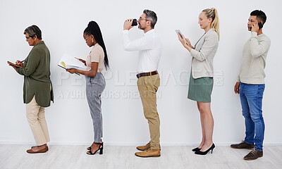 Buy stock photo Line of diverse businesspeople waiting in line using tech devices before interview. Group of mature and young business colleagues standing in a row reading reports, drinking coffee before a meeting
