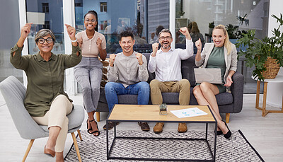 Buy stock photo Full body portrait of diverse group of business people cheering while sitting in the office at night. Team of professional workers celebrating beating a deadline while working late in the workplace