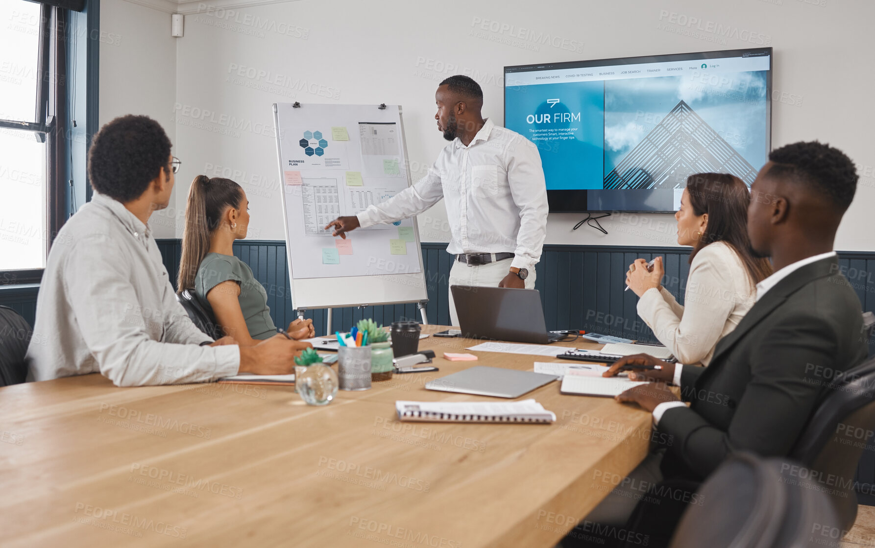 Buy stock photo A group of young diverse corporate business people working as a team on a project in a boardroom. African American man speaker using a chart and graph to discuss statistics and planning a strategy 