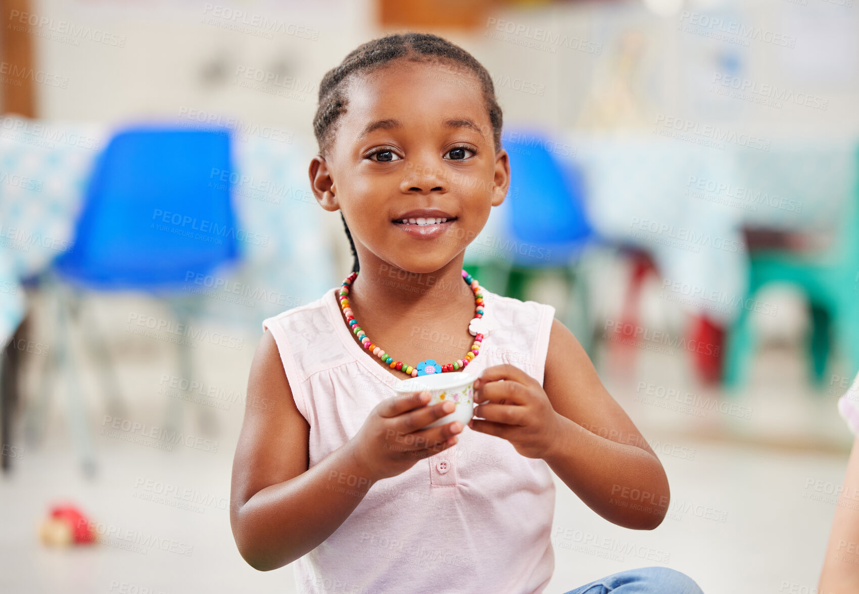 Buy stock photo Portrait, little girl and cup with smile in kindergarten, daycare or classroom for playing. African kid, youth and happy for fun with delicious, fresh and beverage for development of motor skills