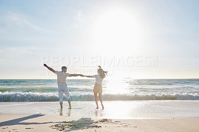 Buy stock photo Full length shot of an affectionate young couple having fun on the beach