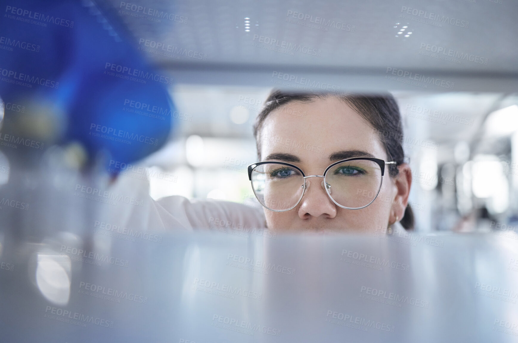 Buy stock photo Science, search and the eyes of a woman in a laboratory for research, innovation or medical storage. Healthcare, medical and pharmaceuticals with a young scientist in a lab for cure development